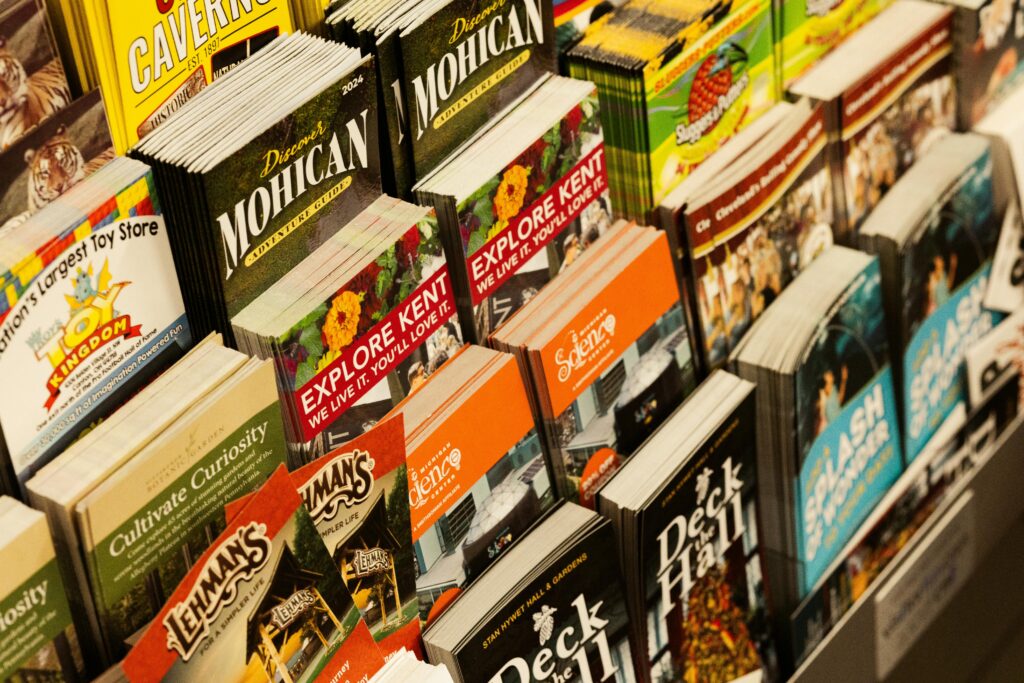 Colorful collection of travel brochures on display at a bookstore.